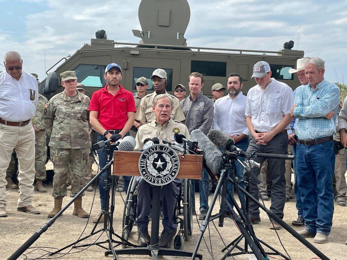 Texas Gov. Greg Abbott with state and local officials, speaks about the border crisis under the international bridge in Del Rio, Texas, on Sept. 20, 2021. (Charlotte Cuthbertson/The Epoch Times)
