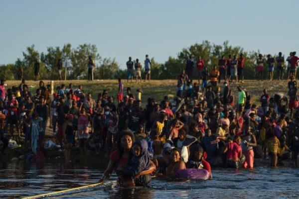 Haitian migrants continue to cross across the U.S.–Mexico border on the Rio Grande as seen from Ciudad Acuña, Coahuila, Mexico, on Sept. 20, 2021. (Paul Ratje/AFP via Getty Images)