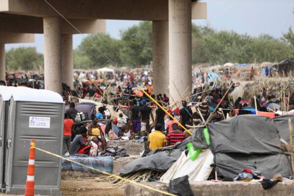 Thousands of illegal immigrants, mostly Haitians, live in a primitive, makeshift camp under the International Bridge, which spans the Rio Grande between the U.S. and Mexico while waiting to be detained and processed by Border Patrol, in Del Rio, Texas, on Sept. 21, 2021. (Charlotte Cuthbertson/The Epoch Times)