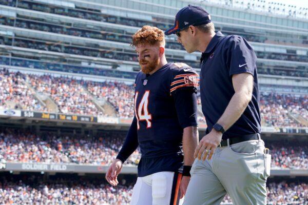 Chicago Bears quarterback Andy Dalton walks to the locker room with an unidentified trainer during the first half of an NFL football game against the Cincinnati Bengals in Chicago, Ill., on Sept. 19, 2021. (Nam Y. Huh/AP Photo)