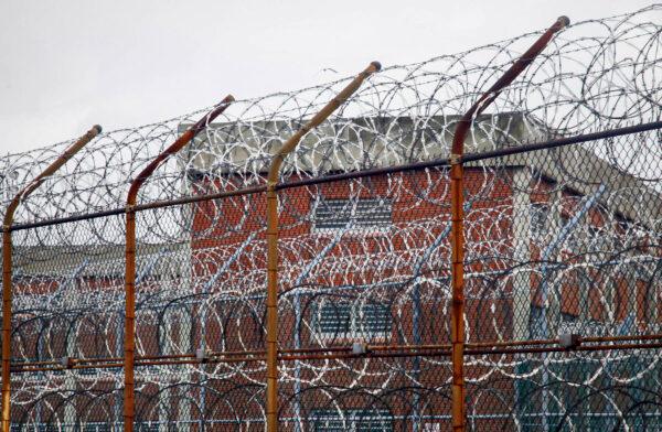 This file photo shows a barbed wire fence outside inmate housing on New York's Rikers Island correctional facility in New York. (Bebeto Matthews/AP Photo)