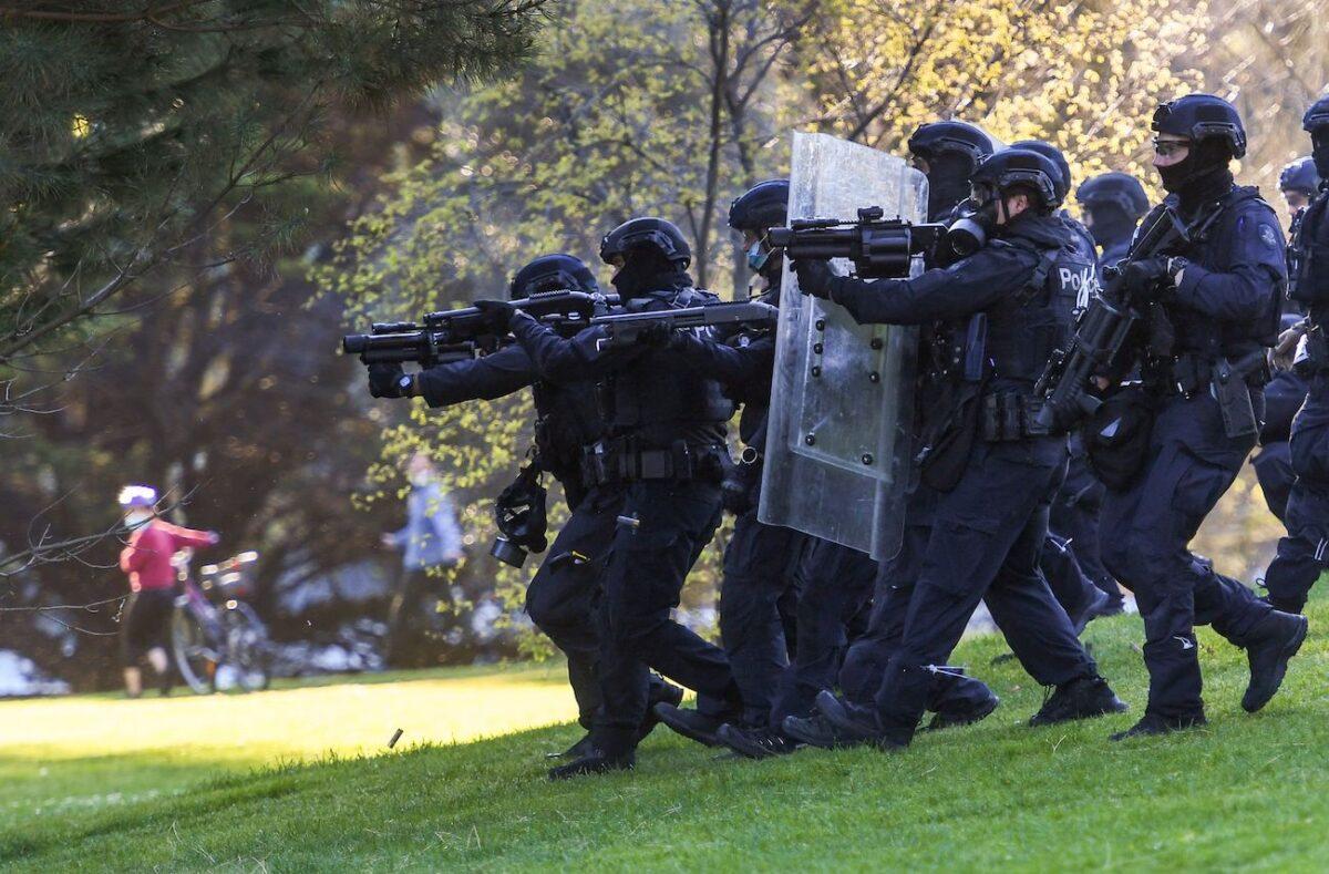 Police fire capsicum spray towards construction workers and demonstrators in the gardens surrounding the Shrine of Remembrance during a protest against Covid-19 regulations in Melbourne, Australia, on Sept. 22, 2021. (William West/AFP via Getty Images)