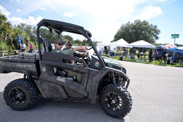 Florida Fish and Wildlife Commission officers ride past media stationed at the entrance of the Carlton Reserve during a search for Brian Laundrie, in Venice, Fla., on Sept. 21, 2021. (Phelan M. Ebenhack/AP Photo)
