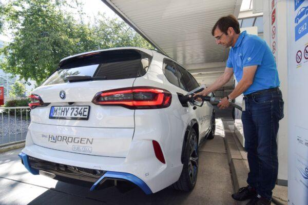Juergen Guldner, a vice president at BMW in charge of the carmaker's hydrogen car program, fuels a hydrogen fuel-cell prototype SUV in Munich on Sept. 3, 2021. (Nick Carey/Reuters)