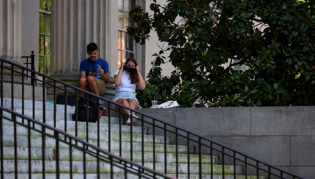A person puts on a mask outside the closed Wilson Library at the campus of the University of North Carolina at Chapel Hill, North Carolina, on Aug. 18, 2020. (Melissa Sue Gerrits/Getty Images)