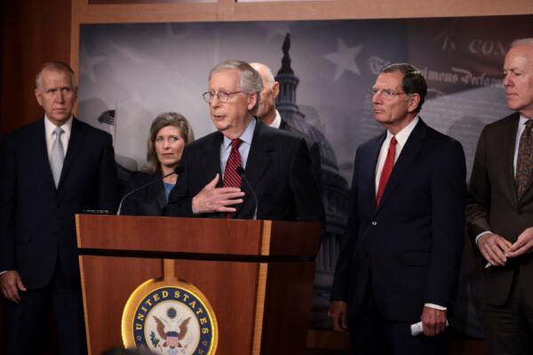 Senate Minority Leader McConnell (R-Ky.), center, speaks to reporters as other senators stand by, in Washington on Sept. 22, 2021. (Anna Moneymaker/Getty Images)