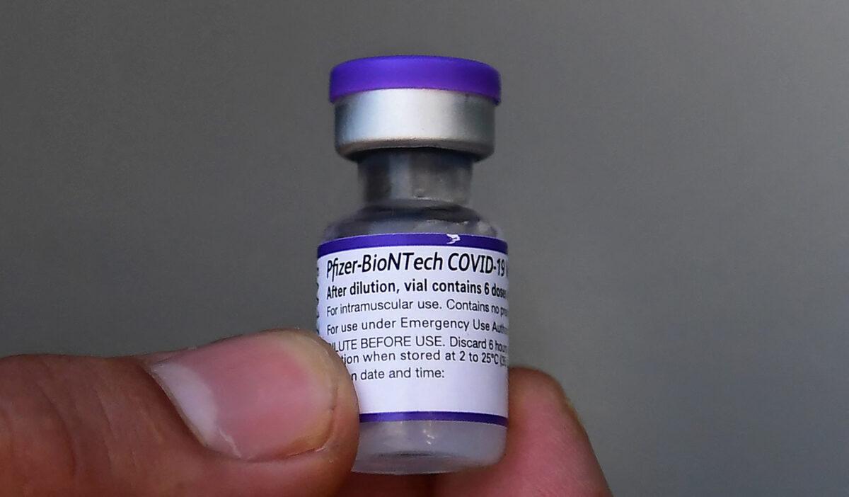 A five-dose vial of the Pfizer COVID-19 vaccine is held in Los Angeles, Calif., on Sept. 21, 2021. (Frederic J. Brown/AFP via Getty Images)