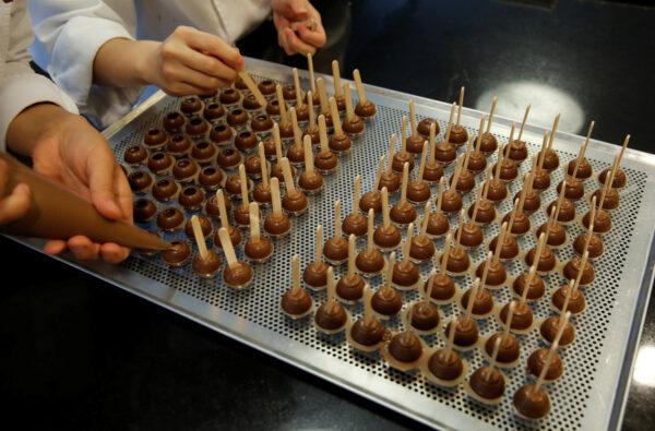 Employees of chocolate and cocoa product maker Barry Callebaut prepare chocolates after the company's annual news conference in Zurich, Switzerland, on Nov. 7, 2018. (Arnd Wiegmann/Reuters)