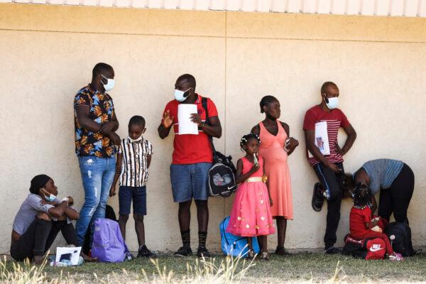 Haitians who crossed the U.S. border illegally have been processed by Border Patrol and are dropped at local NGO Border Humanitarian Coalition to catch a bus to San Antonio or Houston, in Del Rio, Texas, on Sept. 22, 2021. (Charlotte Cuthbertson/The Epoch Times)