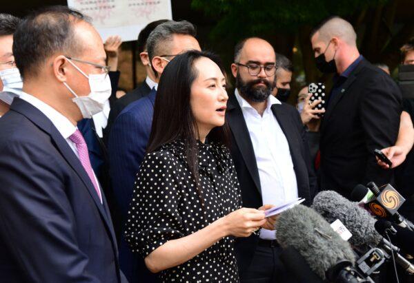 Huawei Chief Financial Officer Meng Wanzhou (C) talks to media outside of the British Columbia Supreme Court in Vancouver, Canada, on Aug. 18, 2021. (Don MacKinnon/AFP via Getty Images)