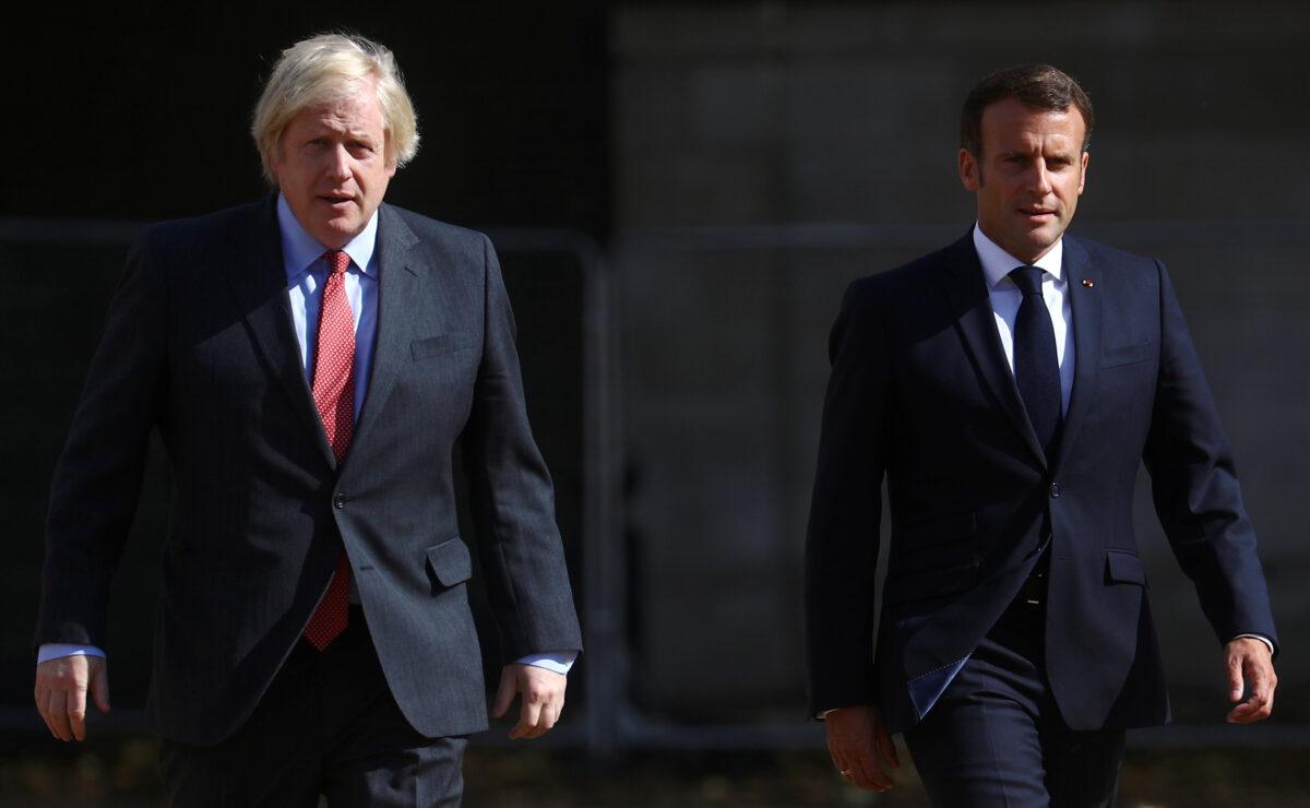 British Prime Minister Boris Johnson and French President Emmanuel Macron walk in London, Britain, on June 18, 2020. (Hannah McKay/Reuters)