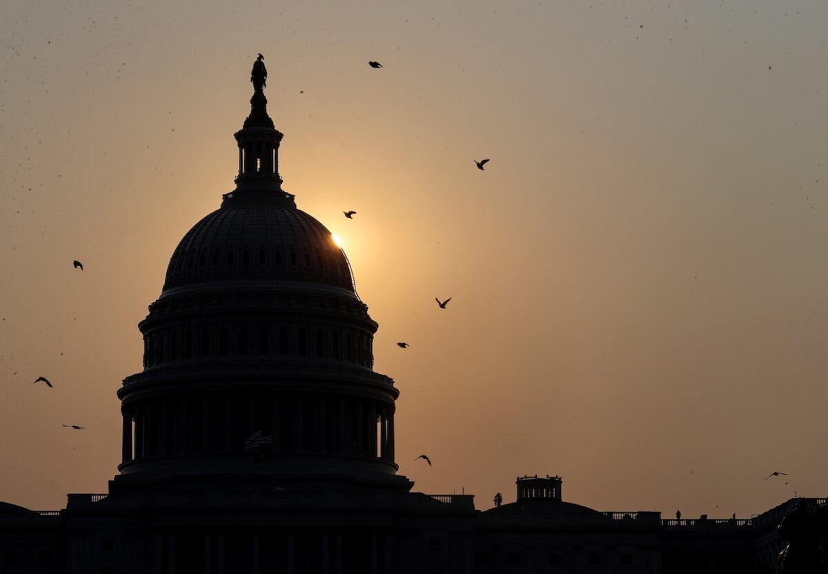 The sun rises behind the U.S. Capitol on Sept. 13, 2021. (Jonathan Ernst/Reuters)