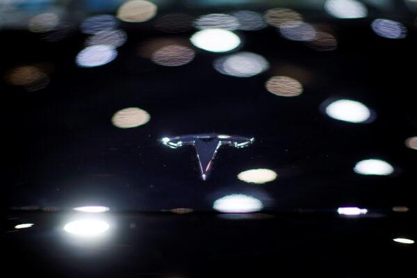 A Tesla logo is seen on the body of its electric vehicle during a media day for the Auto Shanghai show in Shanghai, China on April 20, 2021. (Aly Song/Reuters)