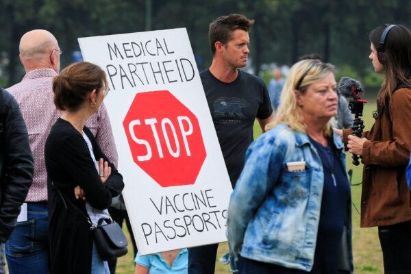 People take part in a protest on the day the Dutch authorities introduce a mandatory "corona pass," proof of COVID-19 vaccination or a negative test result, to enter bars, restaurants, and cultural events in the country, in The Hague, Netherlands, on Sept. 25, 2021. (Eva Plevier/Reuters)