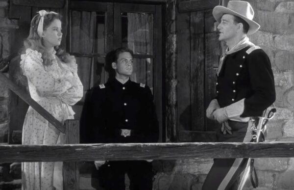 (L–R) Philadelphia (Shirley Temple), 2nd Lt. O’Rourke (John Agar), and Capt. York (John Wayne), in “Fort Apache.” (RKO Radio Pictures)