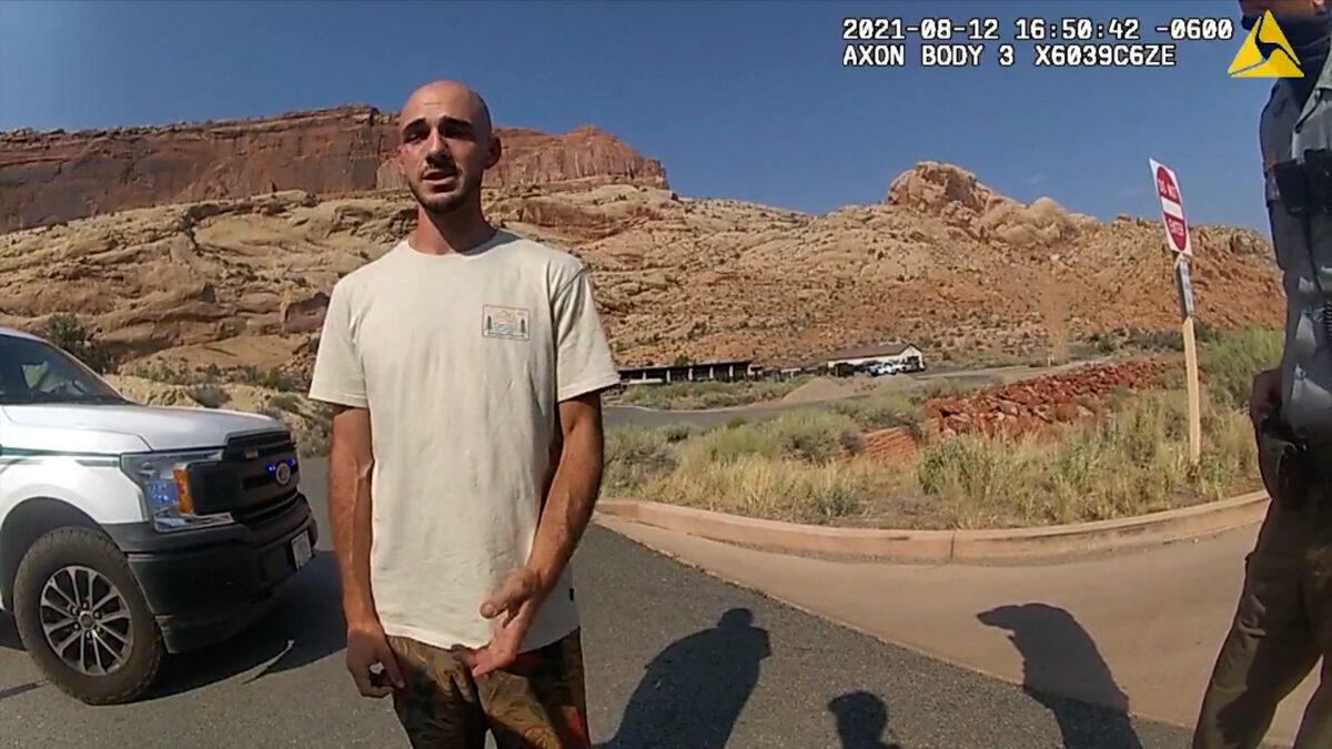 In this screenshot from a police camera video, Brian Laundrie talks to a police officer after police pulled over the van he was traveling in with his girlfriend, Gabrielle “Gabby” Petito, near the entrance to Arches National Park, Utah, on Aug. 12, 2021. (The Moab Police Department)