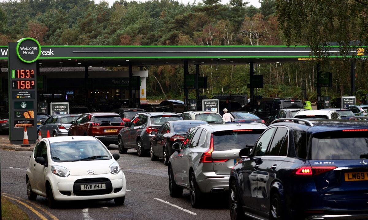 Motorists queue for petrol and diesel fuel at a petrol station off of the M3 motorway near Fleet, west of London on Sept. 26, 2021. (Photo by Adrian Dennis/AFP via Getty Images)