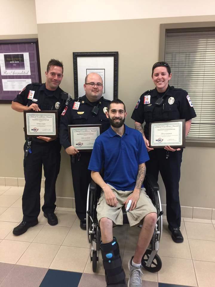 Caleb with the paramedics who performed on-site life-saving interventions and transported him to the hospital. The officers were later honored with the "clinical excellence" award for saving Caleb's life. (Courtesy of <a href="https://www.instagram.com/calebtrahan/">Caleb Trahan</a>)