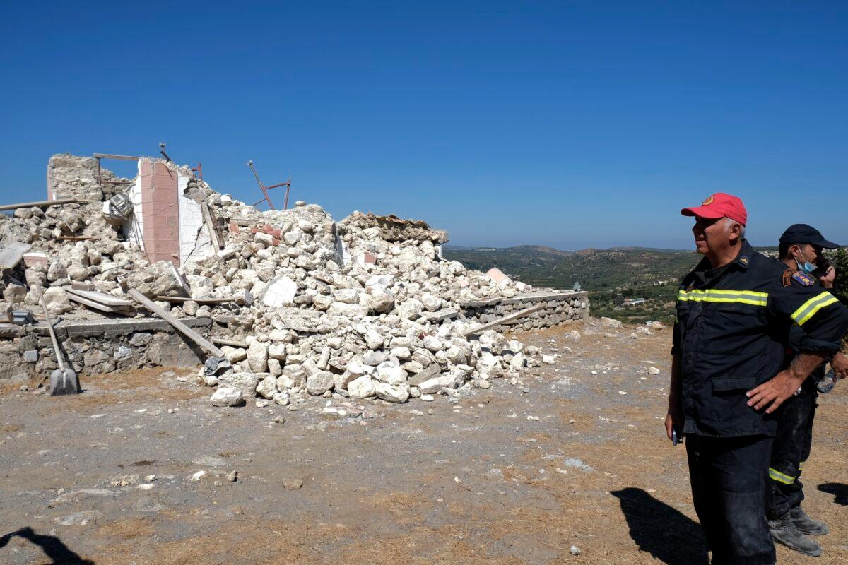 Firefighters stand next to a demolished Greek Orthodox church of Profitis Ilias after a strong earthquake in Arkalochori village on the southern island of Crete, Greece, on Sept. 27, 2021. (Harry Nikos/AP Photo)