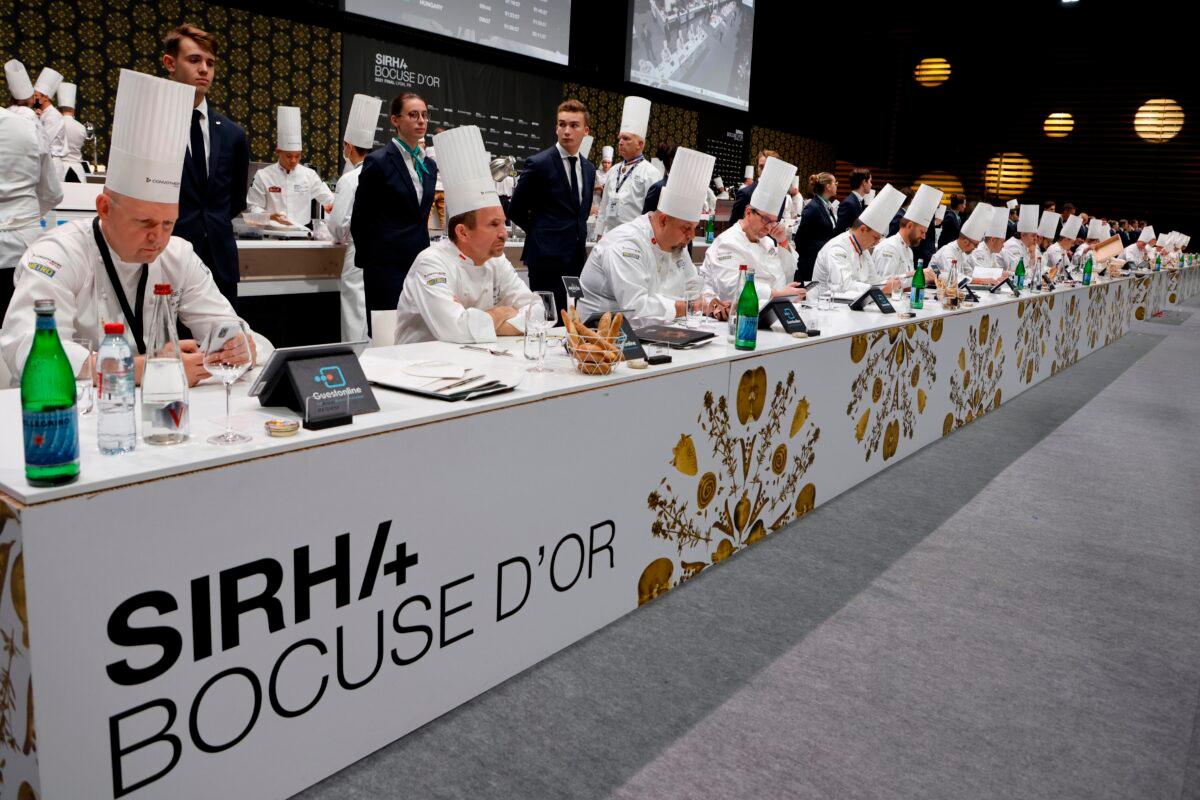 Jury members of the Bocuse d'Or gastronomy contest are pictured during a visit of French President at the International Catering, Hotel and Food Trade Fair (SIRHA) in Lyon, central France, on Sept. 27, 2021. (Ludovic Marin/Pool via AP)