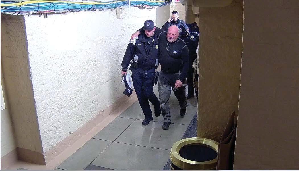 John Anderson is seen being helped by police officers after being pepper sprayed in Washington on Jan. 6, 2021. (FBI)