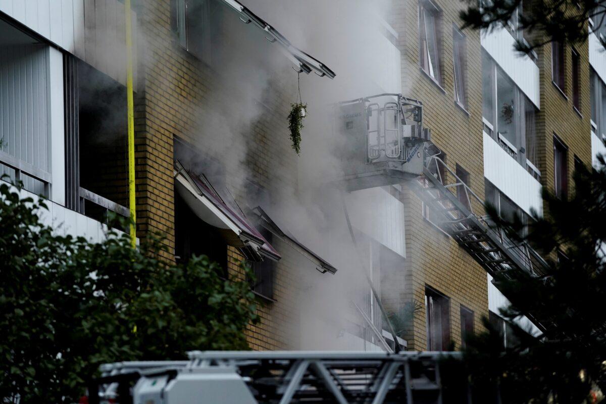 Smoke comes out of windows after an explosion hit an apartment building in Annedal, central Gothenburg, Sweden, on Sept. 28, 2021. (Larsson Rosvall/TT News Agency via Reuters)