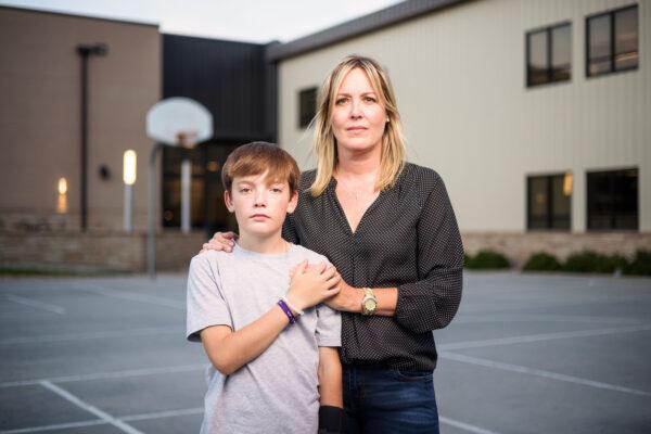 Resurrection Christian School sixth-grader Lincoln Fagerlin, 11, stands with his mother, Christy Fagerlin, outside the school in Loveland, Colo., on Sept. 27, 2021. (Michael Ciaglo for The Epoch Times)