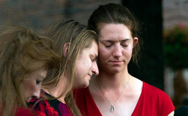 Summerleigh Winters Geimer (C) and her sister Montana Winters Geimer (R), daughters of Wendi Winters, a community beat reporter who was killed in the Capital Gazette newsroom shooting, react during a news conference following the sentencing verdict of Jarrod W. Ramos, in Annapolis, Md., on Sept. 28, 2021. (Jose Luis Magana/AP)