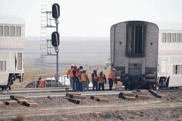 Workers examine a train car from an Amtrak train that derailed near Joplin, Mont., on Sept. 27, 2021. (Ted S. Warren/AP Photo)
