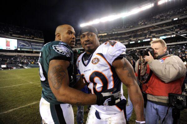 Denver Broncos safety Brian Dawkins (20) and Philadelphia Eagles defensive end Juqua Parker (75) meet on the field at the end of an NFL football game in Philadelphia, Pa., on Dec. 27, 2009. (Michael Perez/AP Photo)