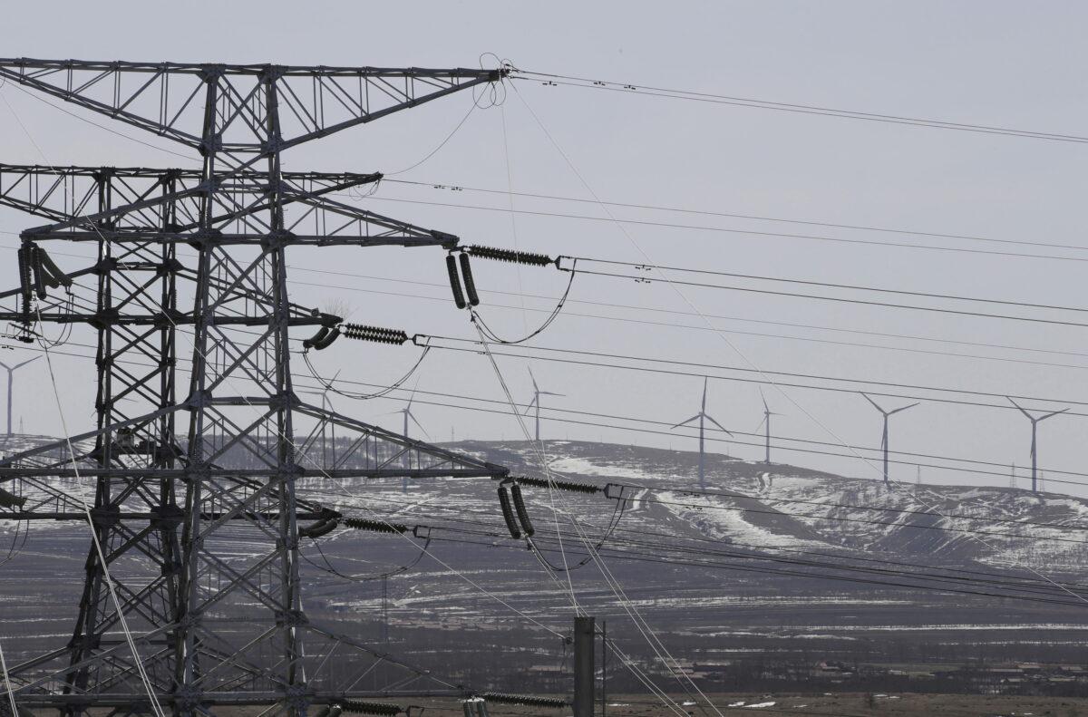 Power lines and wind turbines are pictured at a wind and solar energy storage and transmission power station of State Grid Corporation of China, in Zhangjiakou of Hebei Province, China, on March 18, 2016. (Jason Lee/Reuters)