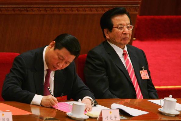 Zeng Qinghong (R) looks on while Politburo member Xi Jinping (L) fills his ballot during the fifth plenary session of the National People's Congress at the Great Hall of the People on March 15, 2008, in Beijing, China. (Feng Li/Getty Images)