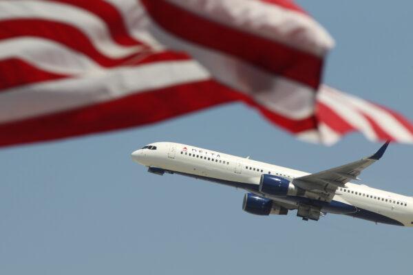 A 2013 file image of an airline jet passing an American flag during take-off at Los Angeles International Airport on April 22, 2013. (David McNew/Getty Images)