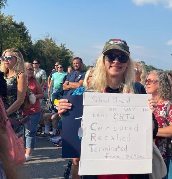 A woman holding a sign at a rally outside the Loudoun County Public Schools administration building in Ashburn, Va., on Sept. 28, 2021. (Terri Wu/The Epoch Times)