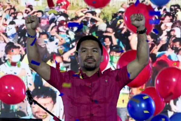 Senator Manny Pacquiao raises his hands during a national convention of his PDP-Laban party in Quezon City, Philippines, on Sept. 19, 2021. (Manny Pacquiao MediaComms via AP)