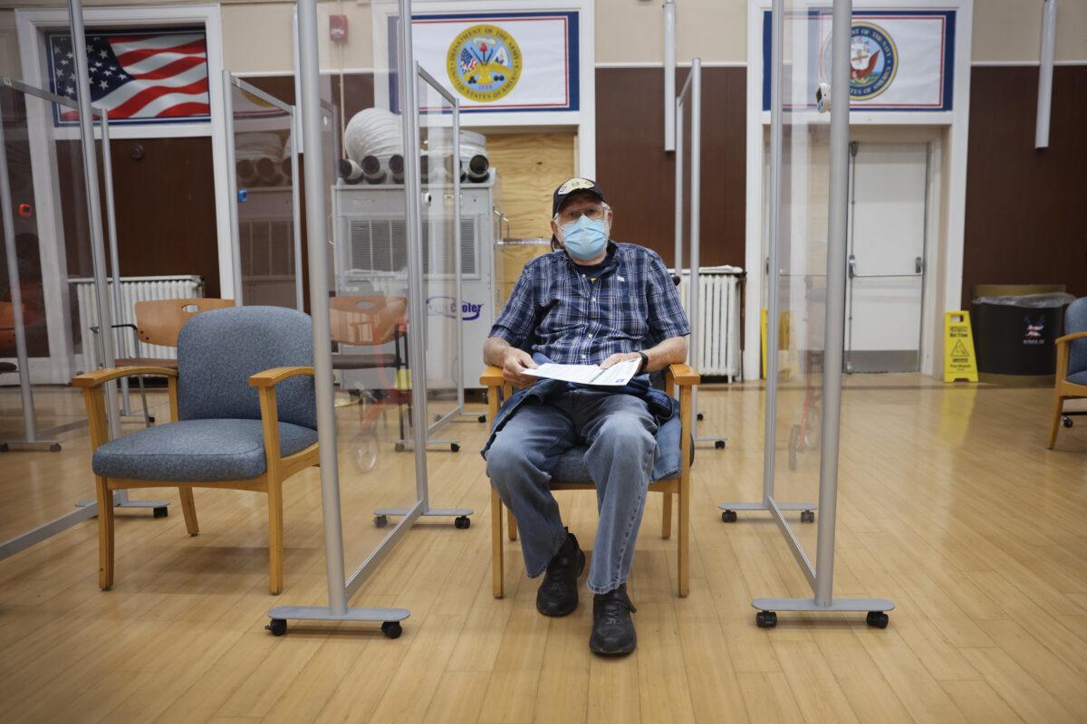 An Army veteran waits to see if he has a reaction after receiving a COVID-19 booster vaccine at a Veterans Affairs hospital in Hines, Ill., on Sept. 24, 2021. (Scott Olson/Getty Images)