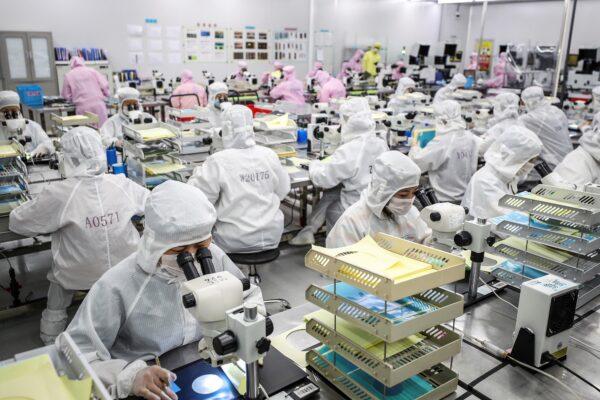 Workers produce LED chips at a factory in Huaian, in China's eastern Jiangsu Province on June 16, 2020. (STR/AFP)