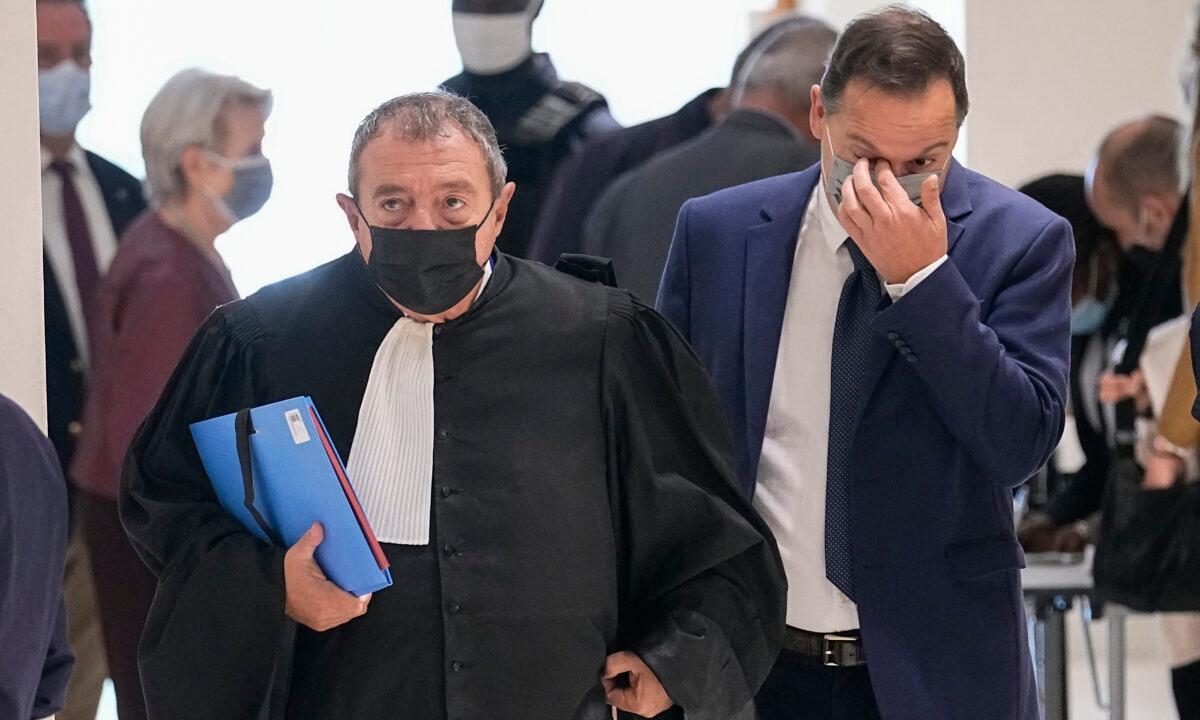 Former President of Bygmalion event compagnie Guy Alves (R), and his lawyer Patrick Maisonneuve arrive for the verdict of the Bygmalion affaire at Paris' courthouse on Sept. 30, 2021. (Michel Euler/AP Photo)