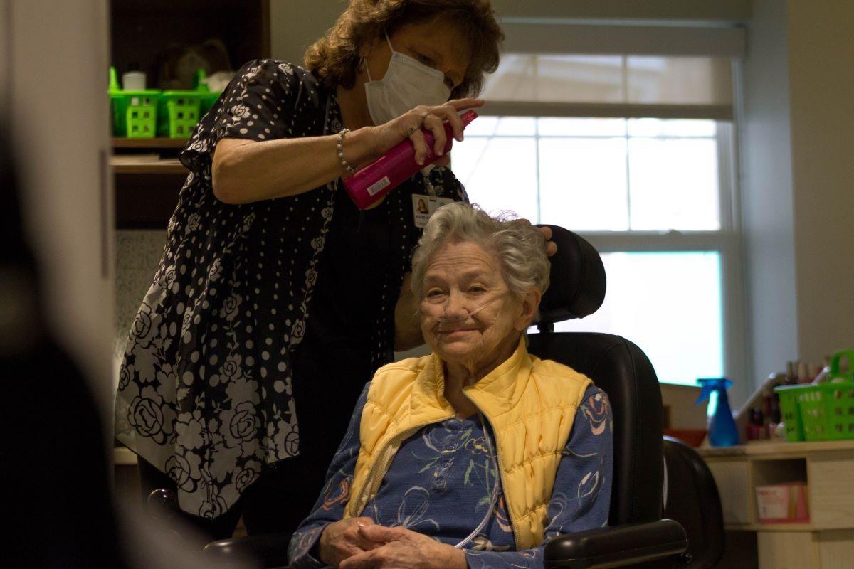 A caregiver treats hair of a nursing home resident at a Quality Life Services facility in western Pennsylvania. (Courtesy of the Pennsylvania Health Care Association)
