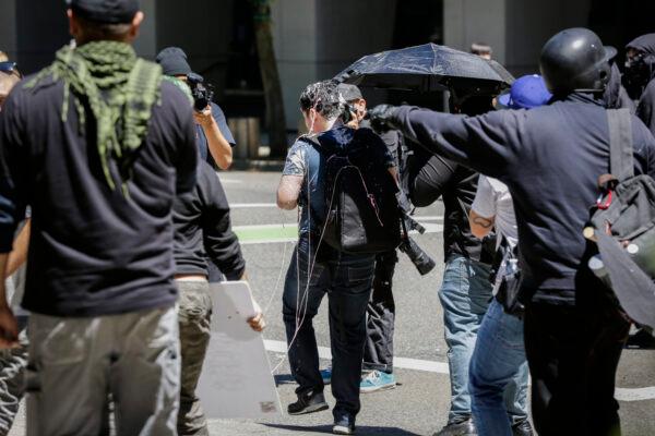 Andy Ngo, a Portland, Ore.-based journalist, is seen covered in an unknown substance after unidentified Rose City Antifa members attacked him in Portland on June 29, 2019. (Moriah Ratner/Getty Images)