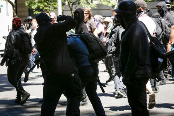 Unidentified Rose City Antifa members beat up Andy Ngo, a Portland, Ore.-based journalist, in Portland on June 29, 2019. (Moriah Ratner/Getty Images)