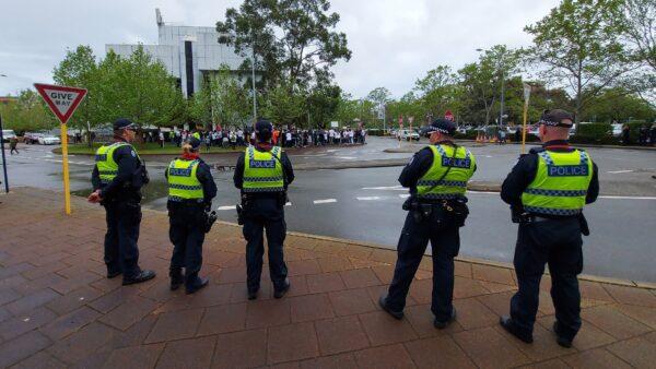 Police keep watch of West Australians gathered to protest mandated vaccine requirements for healthcare workers outside the WA Department of Health building in Perth, Australia on Oct. 1, 2021. (Daniel Khmelev/The Epoch Times)