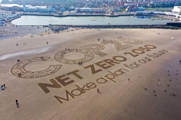 A giant sand artwork adorns New Brighton Beach to highlight the forthcoming COP26 global climate conference on in Wirral, Merseyside, on May 31, 2021. (Christopher Furlong/Getty Images)