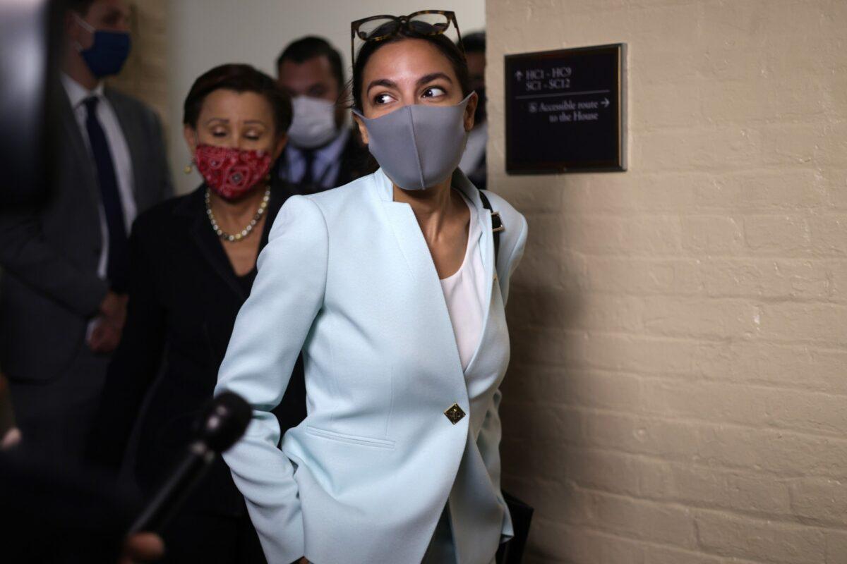 U.S. Rep. Alexandria Ocasio-Cortez (D-N.Y.) (R) leaves after a House Democratic Caucus meeting with President Joe Biden at the U.S. Capitol in Washington Oct. 1, 2021. President Biden called the meeting in order to push through an impasse with his $1 trillion infrastructure plan. (Alex Wong/Getty Images)