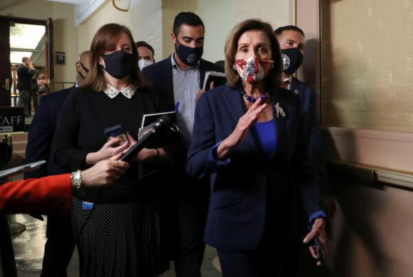 Speaker of the House Nancy Pelosi (D-Calif.) talks with reporters as she leaves a lengthy Democratic caucus meeting in the U.S. Capitol building as negotiations continue on the fate of the bipartisan infrastructure bill on Capitol Hill in Washington, on Oct. 1, 2021. (Leah Millis/Reuters)
