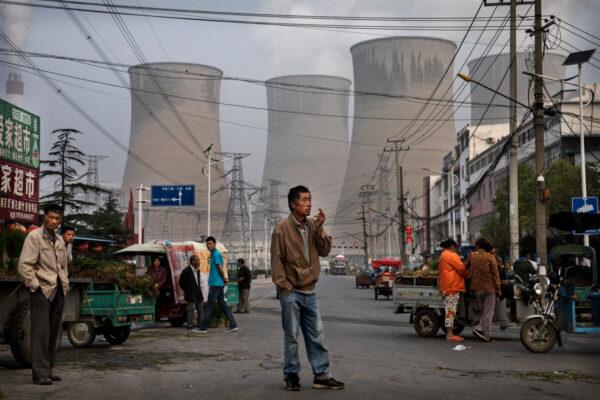 Chinese street vendors and customers gather at a local market outside a state-owned coal fired power plant in Anhui Province, China, on June 14, 2017. (Kevin Frayer/Getty Images)