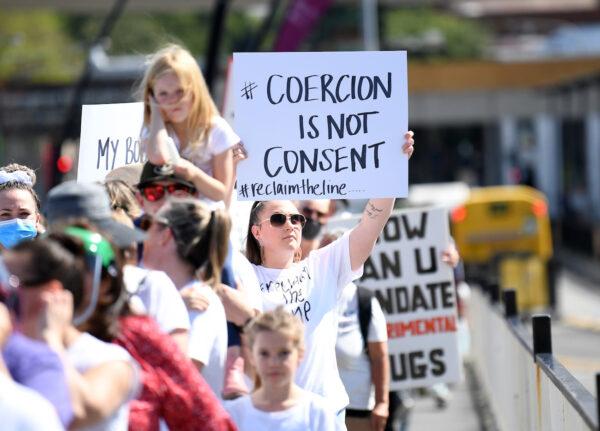 Protesters march across Victoria Bridge during a rally against COVID-19 vaccine mandates, in Brisbane, Australia. #ReclaimTheLine rallies across Australia, on Oct. 1, 2021. (Dan Peled/Getty Images)