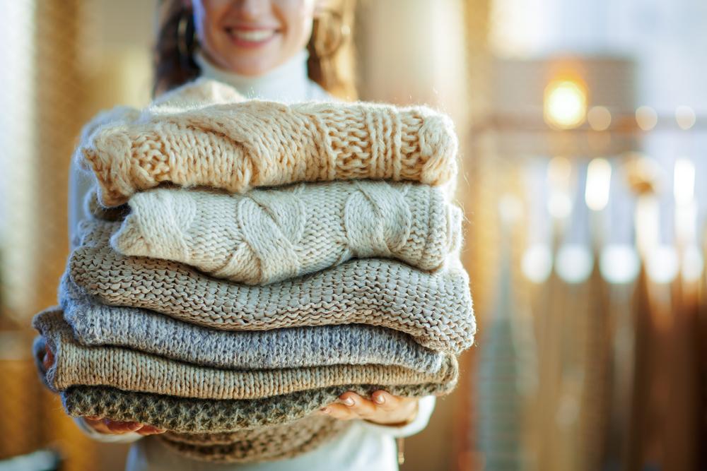 Maximize your space to accommdate your fall and winter sweaters, coats, and scarves—items that tend to be much larger than their spring and summer counterparts. (Alliance Images/Shutterstock)