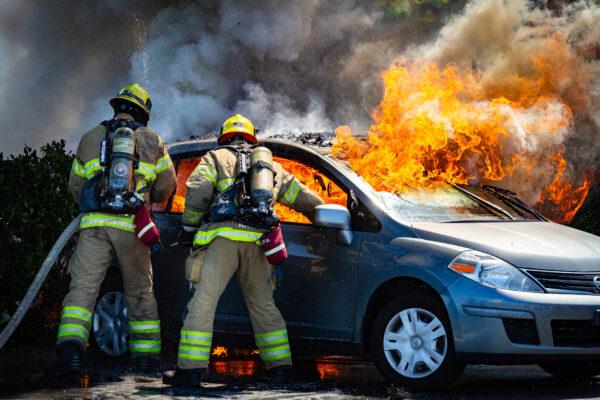 Orange County Fire Authority firefighters extinguish a car fire in Irvine, Calif., on June 11, 2021. (John Fredricks/The Epoch Times)