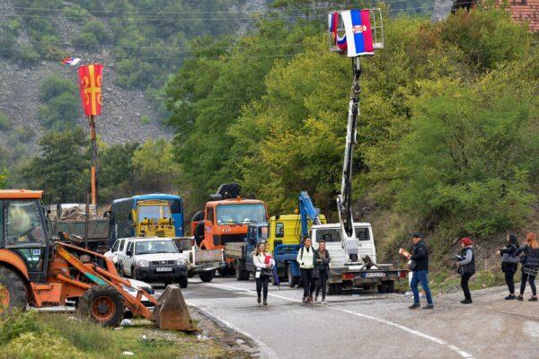 Kosovo ethnic Serbs pass through barricades near the border crossing between Kosovo and Serbia in Jarinje, Kosovo, on Sept. 28, 2021. (Laura Hasani/Reuters)